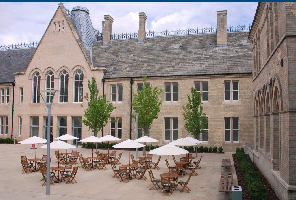 Benefactors court outdoor area with tables and umbrellas