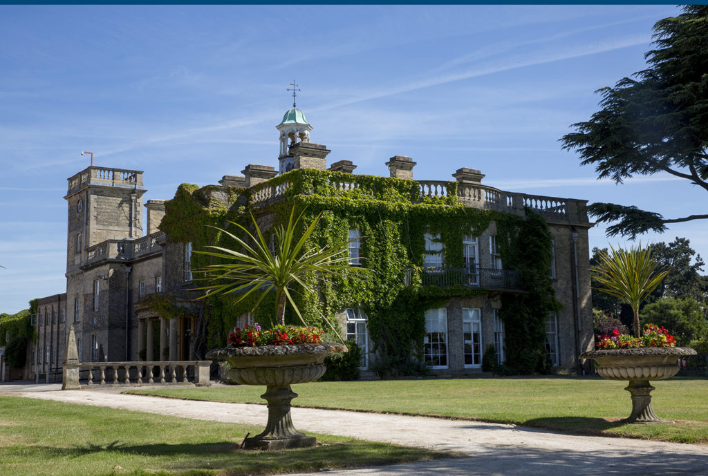 Brackenhurst main hall building with flowers and lawn