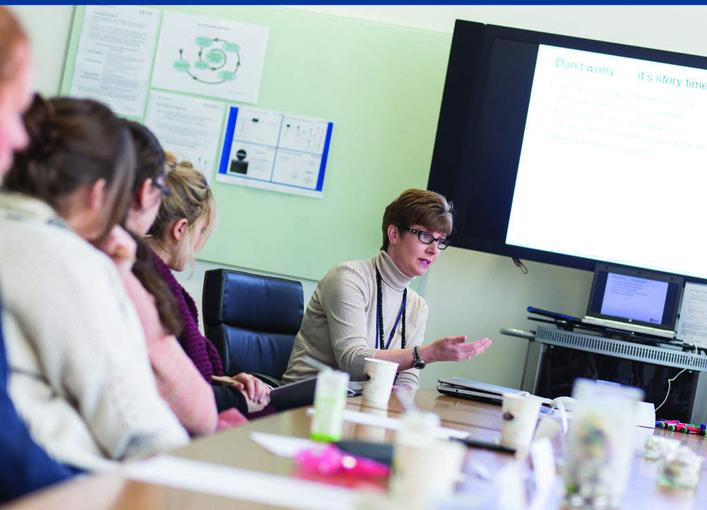 Woman talking to people in a meeting