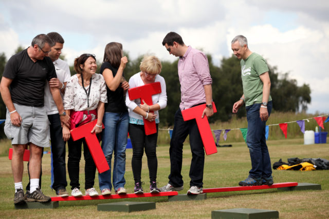 Group playing team building activity, quest for the best