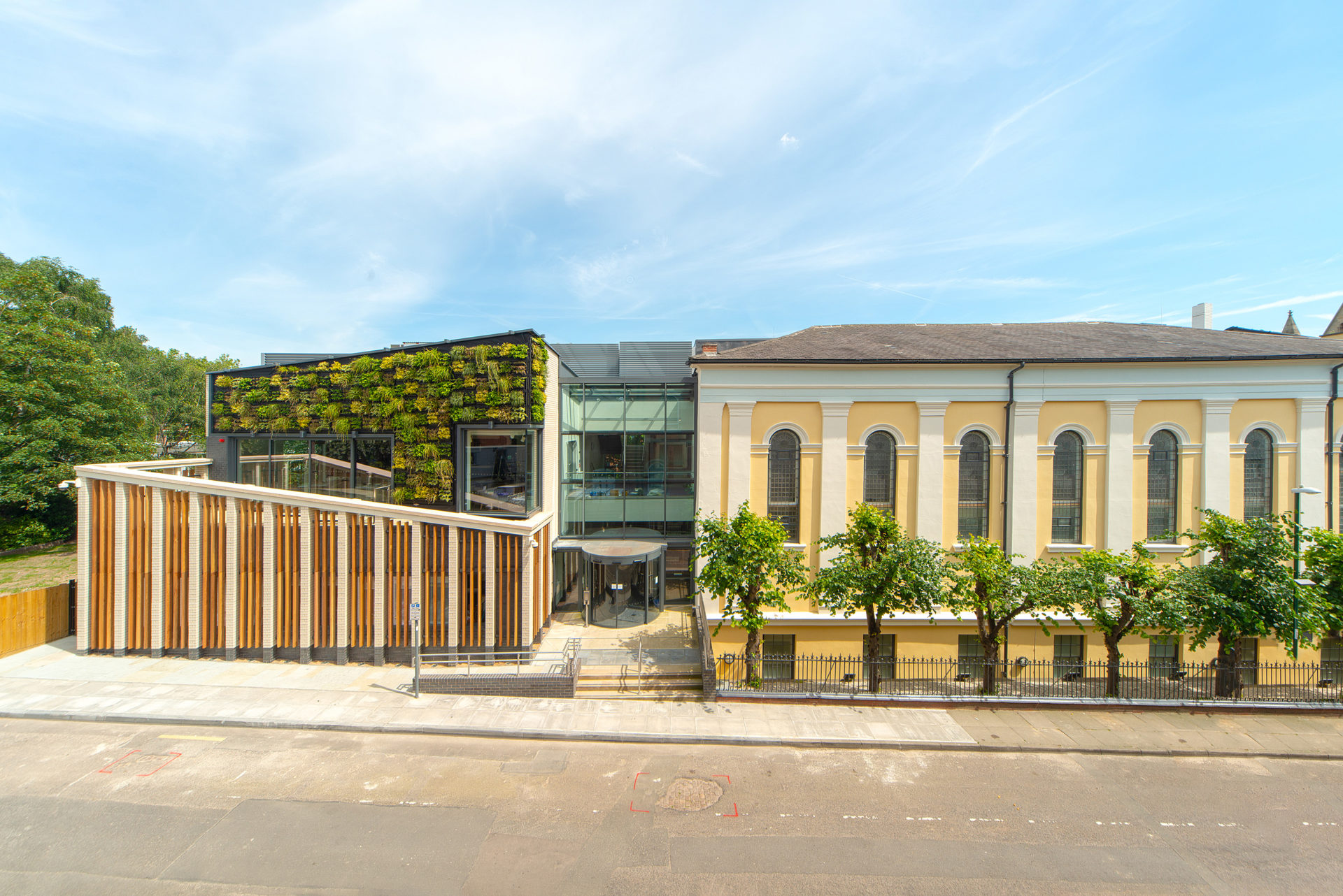 External image of the new University Hall building, clearly showing the green wall and glass vestibule